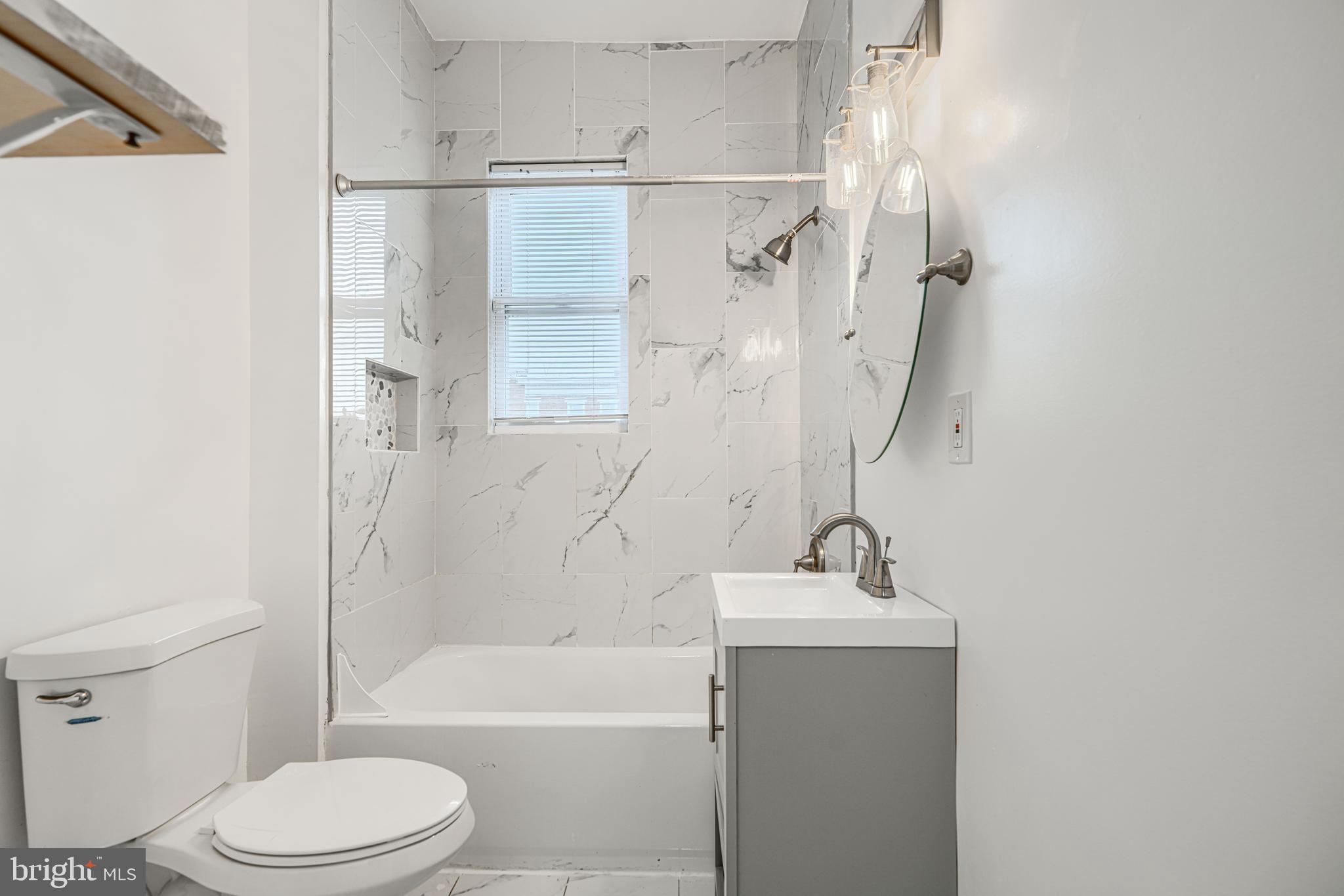 1702 East 32nd Street Baltimore, MD 21218 - Photo 25 of 38 a bathroom with a sink toilet and shower