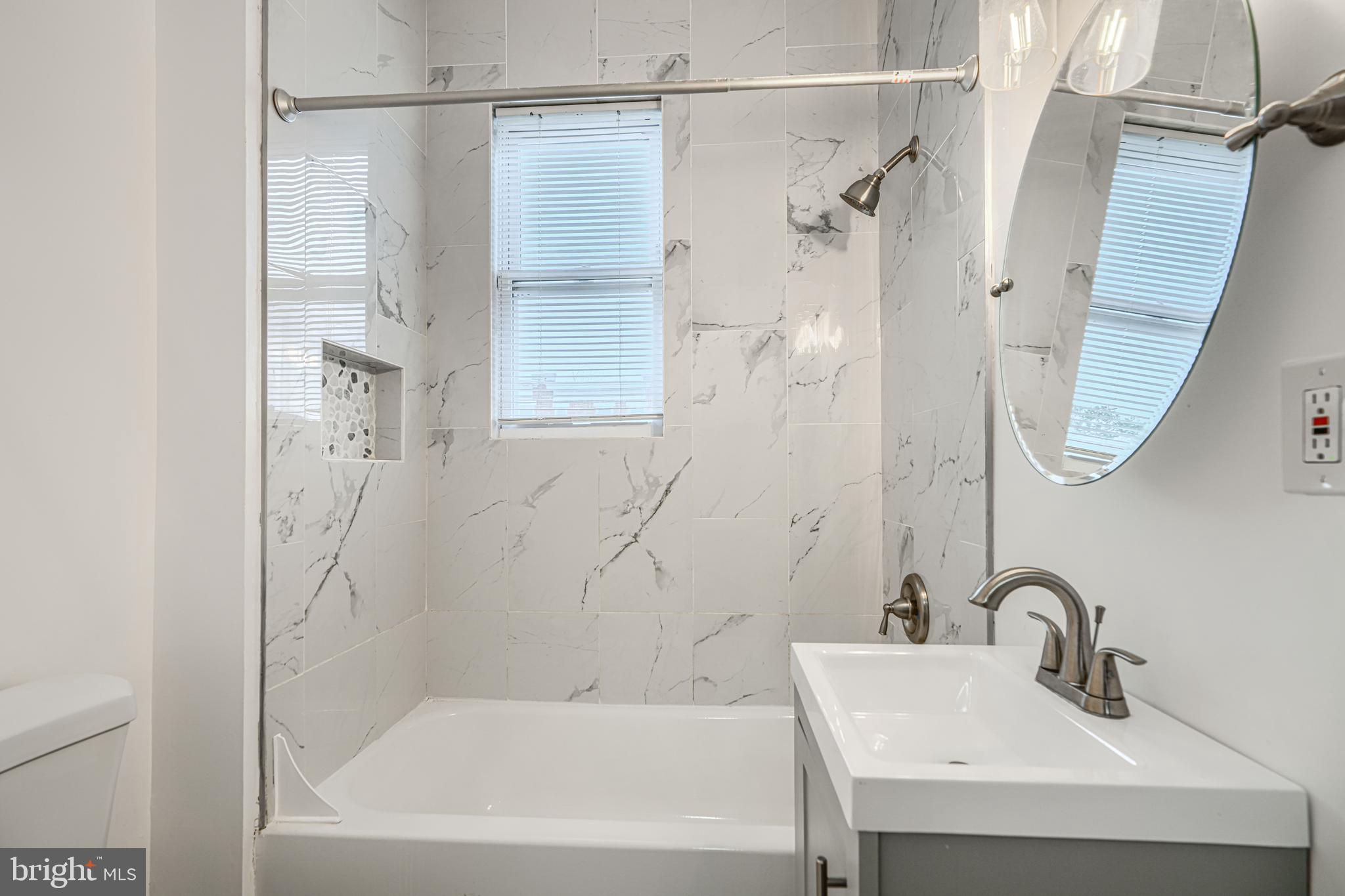 1702 East 32nd Street Baltimore, MD 21218 - Photo 26 of 38 a bathroom with a bathtub and a sink