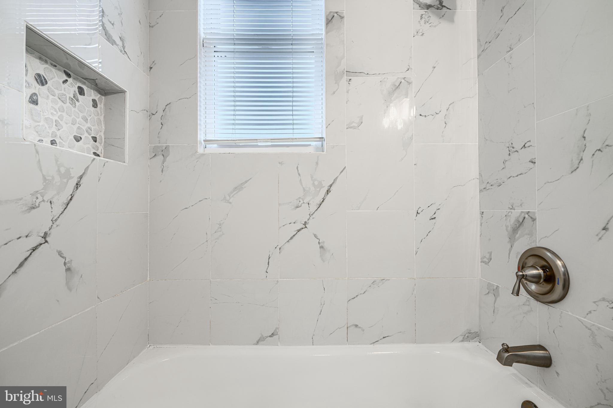 1702 East 32nd Street Baltimore, MD 21218 - Photo 27 of 38 a bathroom with a bathtub and shower