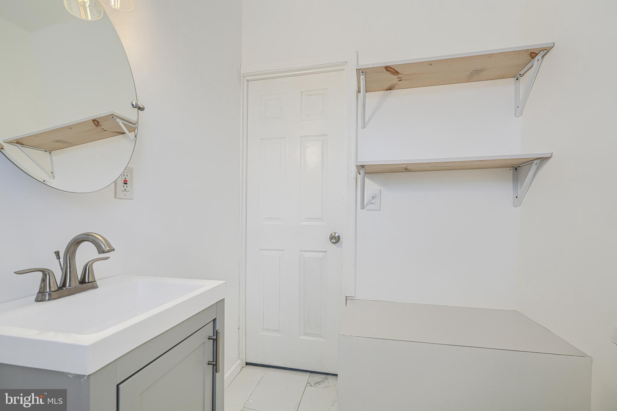 1702 East 32nd Street Baltimore, MD 21218 - Photo 28 of 38 a bathroom with a sink and mirror