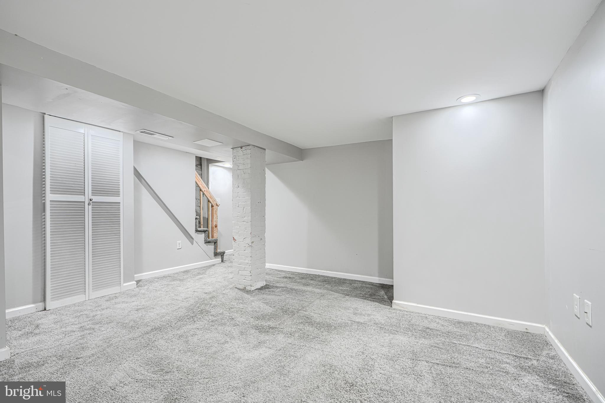 1702 East 32nd Street Baltimore, MD 21218 - Photo 30 of 38 an empty room with a windows and white walls