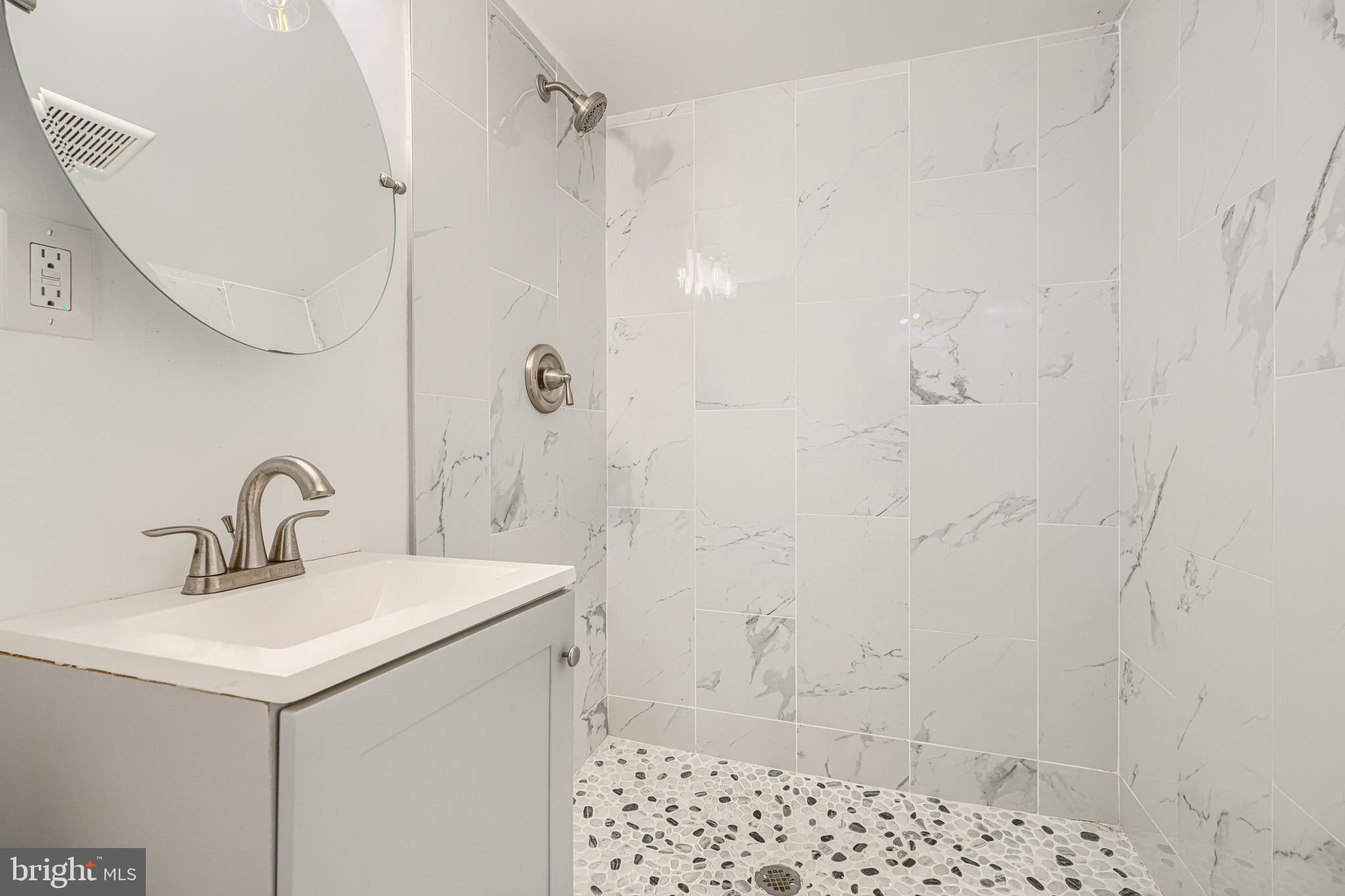 1702 East 32nd Street Baltimore, MD 21218 - Photo 36 of 38 a bathroom with a sink a toilet and shower