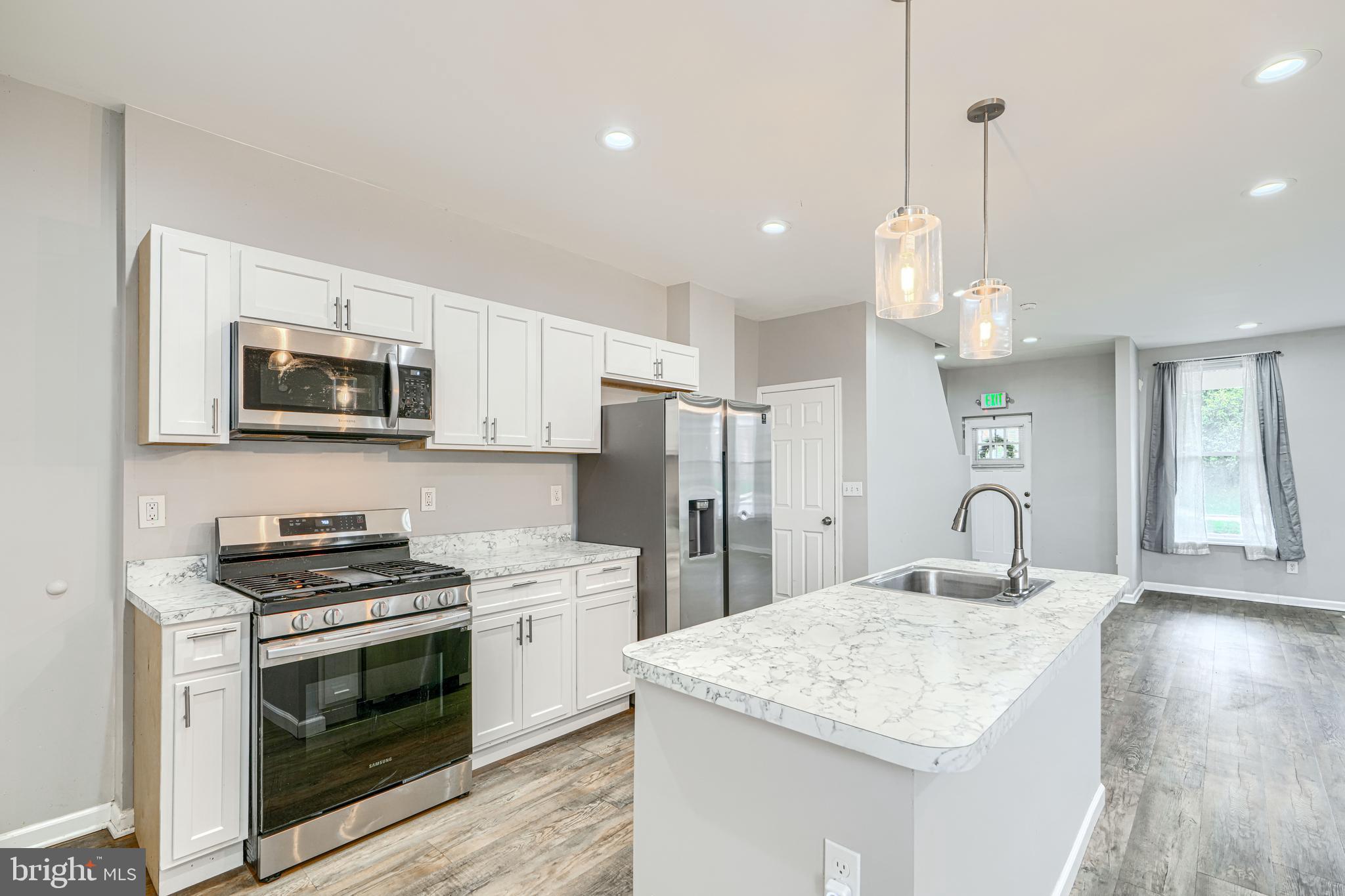 1702 East 32nd Street Baltimore, MD 21218 - Photo 6 of 38 a kitchen with granite countertop a stove and a sink