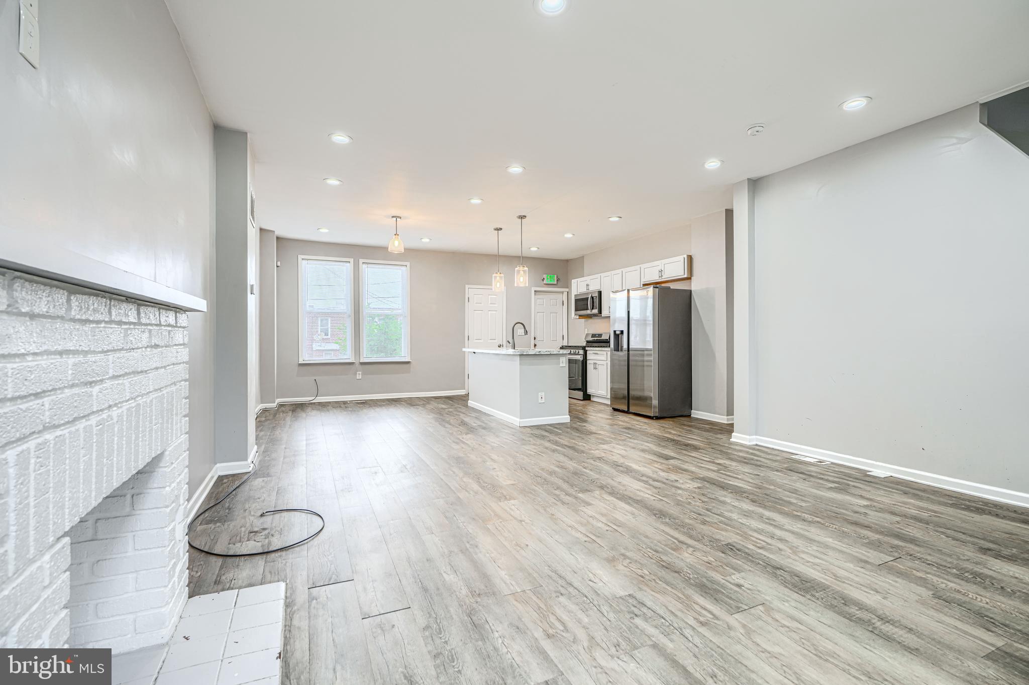 1702 East 32nd Street Baltimore, MD 21218 - Photo 7 of 38 a view of a kitchen with a refrigerator and wooden floor