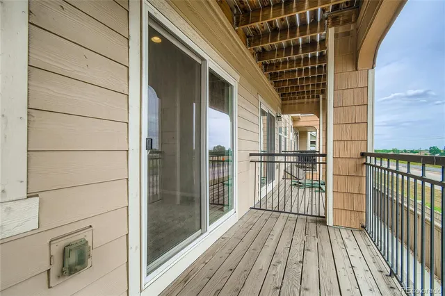 a view of balcony with wooden floor