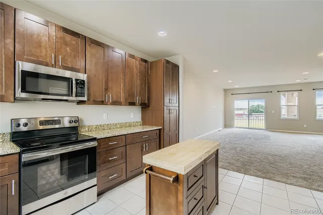 a kitchen with a stove and a microwave