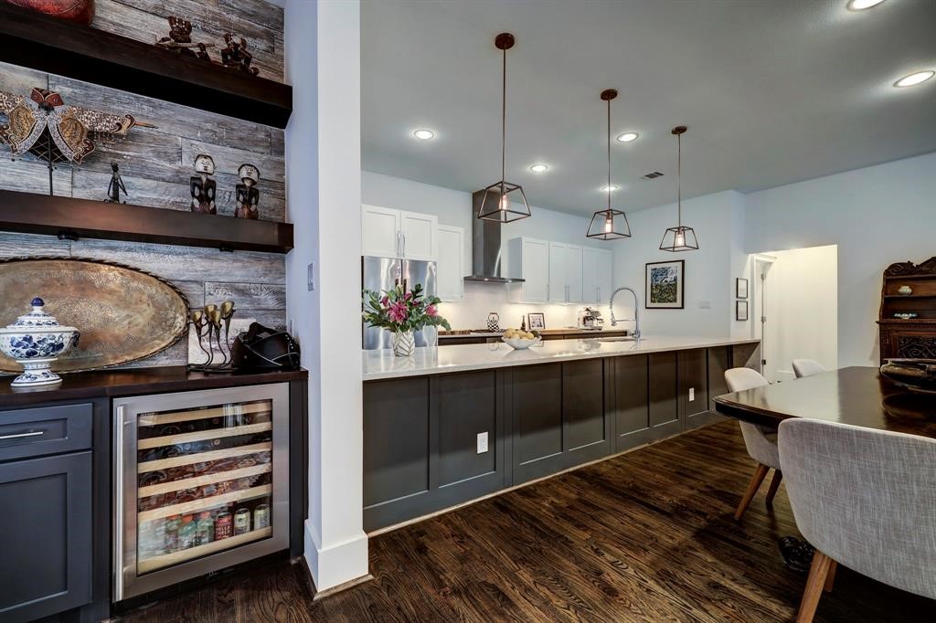 2007 Brun Street, Unit D Houston, TX 77019 - Photo 11 of 25 he bar area highlights the connection to the kitchen and dining, offering a cohesive flow for hosting and gatherings