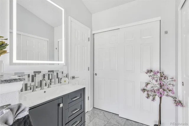 a bathroom with a sink vanity and a mirror