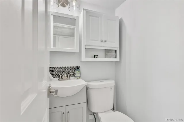 a white toilet sitting next to a bathroom sink