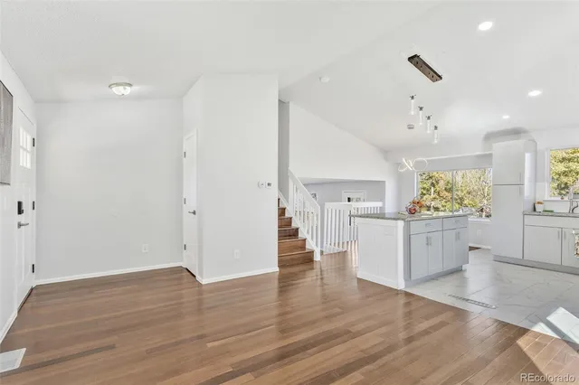 a view of a kitchen and wooden floor