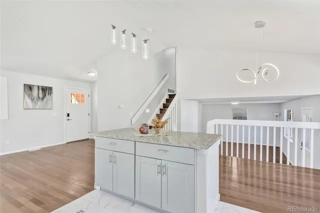 a view of a hallway with entryway and stairs
