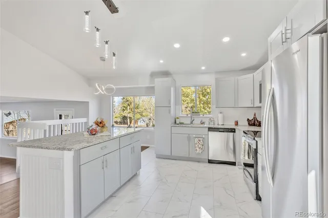 a kitchen with counter top space sink and refrigerator
