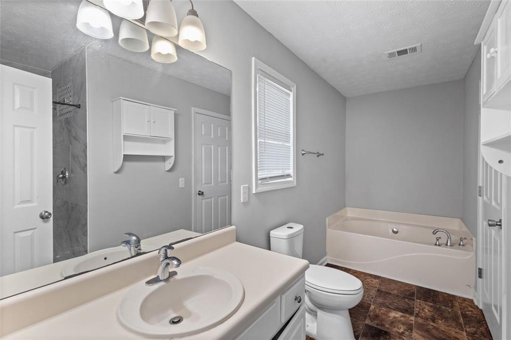 418 Ellerbe Drive Statham, GA 30666 - Photo 15 of 24 a bathroom with a sink a toilet and a mirror