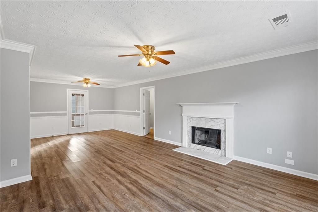 418 Ellerbe Drive Statham, GA 30666 - Photo 2 of 24 a view of empty room with wooden floor and fireplace