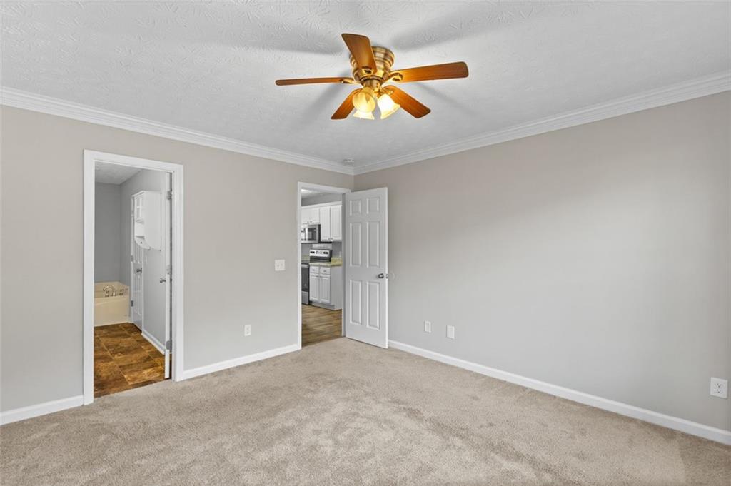 418 Ellerbe Drive Statham, GA 30666 - Photo 5 of 24 an empty room with closet and a ceiling fan