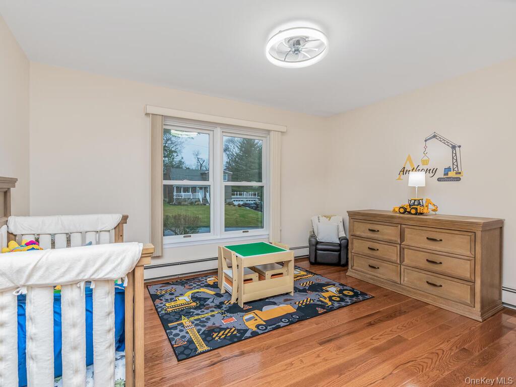 70 Breckenridge Road Mahopac, NY 10541 - Photo 21 of 29 Bedroom featuring a baseboard heating unit and wood finished floors