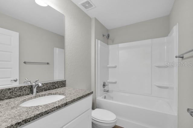 25 Locust Loop Lane Ocala, FL 34472 - Photo 20 of 35 a bathroom with a granite countertop sink a toilet and shower