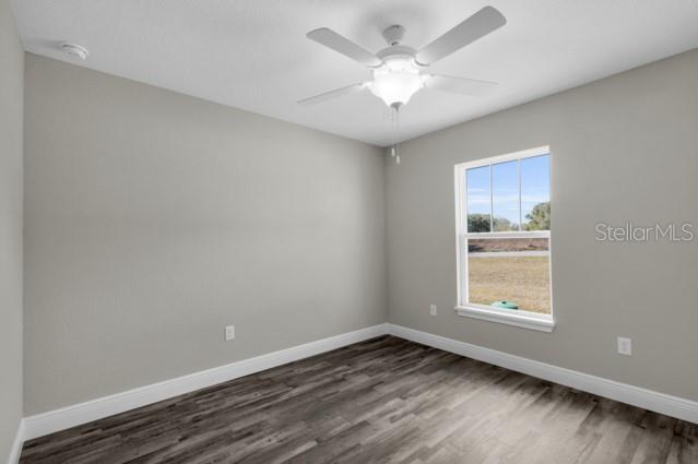 25 Locust Loop Lane Ocala, FL 34472 - Photo 21 of 35 an empty room with wooden floor and windows