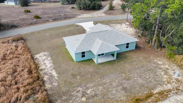 25 Locust Loop Lane Ocala, FL 34472 - Photo 28 of 35 a backyard of a house with table and chairs