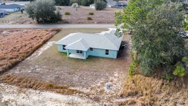 25 Locust Loop Lane Ocala, FL 34472 - Photo 29 of 35 a view of a house with a yard and sitting area