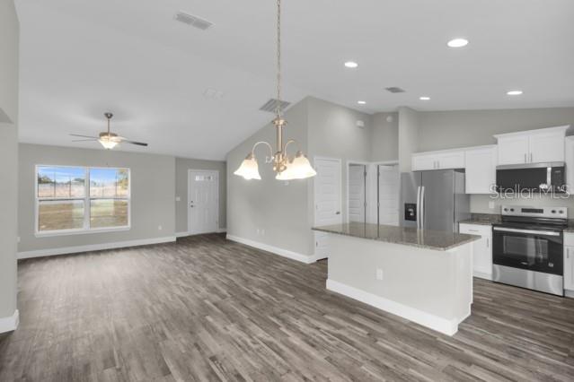 25 Locust Loop Lane Ocala, FL 34472 - Photo 7 of 35 a view of a kitchen with microwave and cabinets