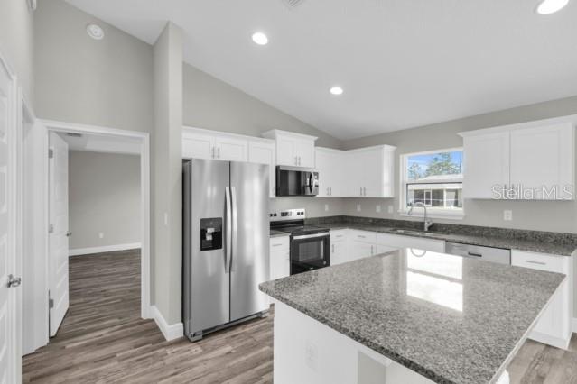 25 Locust Loop Lane Ocala, FL 34472 - Photo 8 of 35 a kitchen with stainless steel appliances granite countertop a refrigerator a sink and a stove