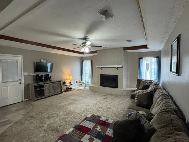 a living room with furniture and a fireplace