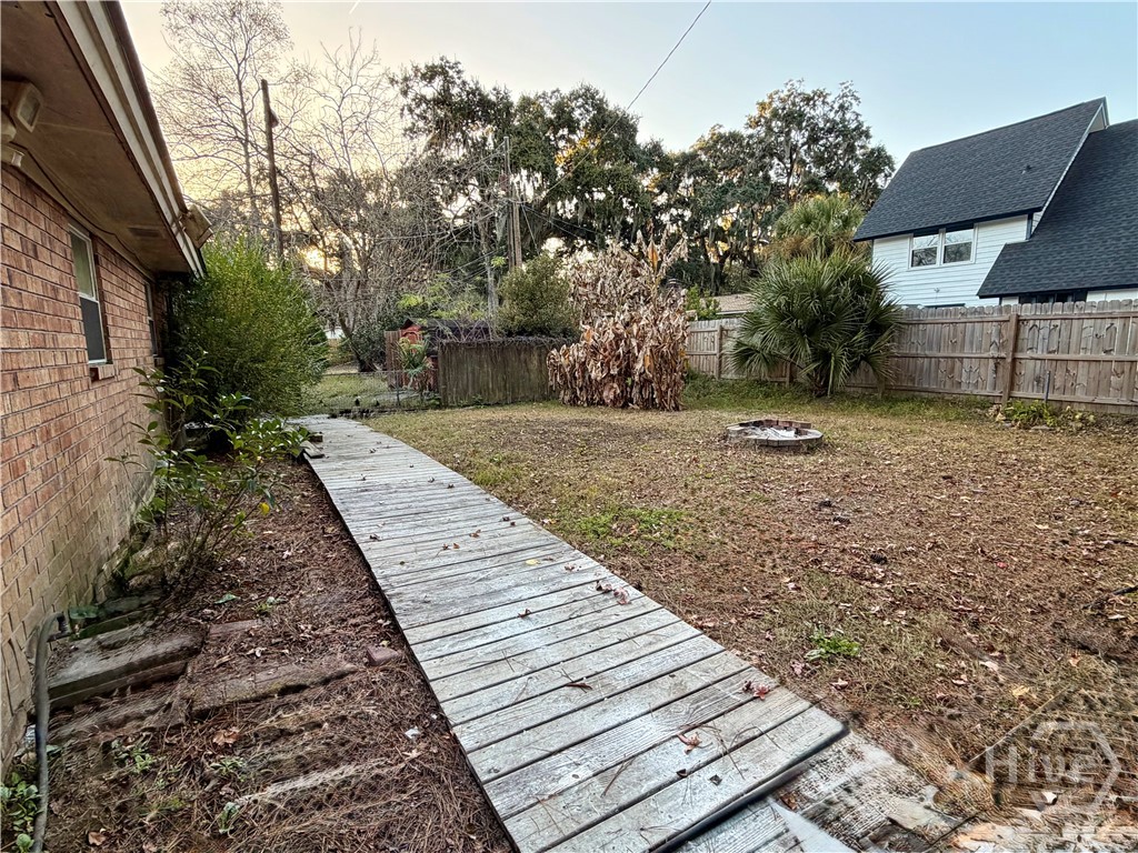 302 Burlington Road Savannah, GA 31410 - Photo 27 of 30 Backyard with wooden walkway to the storage shed