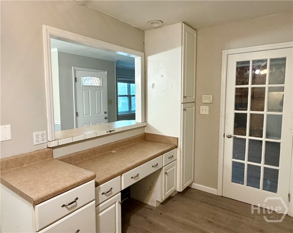 302 Burlington Road Savannah, GA 31410 - Photo 10 of 30 Built in desk and side pantry in the kitchen with atrium door to the GR