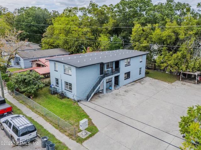 an aerial view of a house with a yard