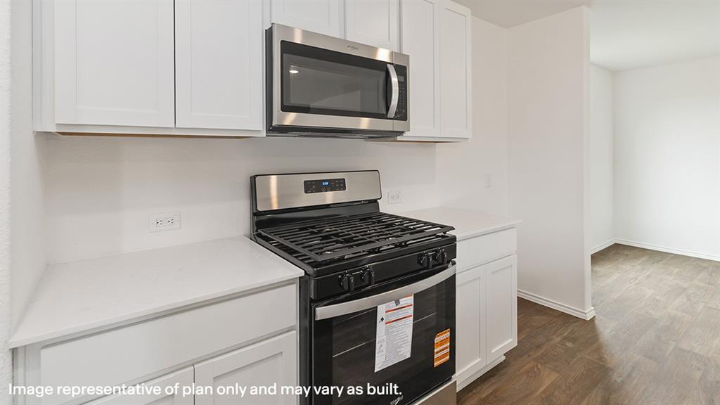 1711 Potomac Lane Blue Ridge, TX 75424 - Photo 17 of 26 a kitchen with granite countertop a stove and a microwave