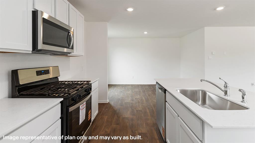 1711 Potomac Lane Blue Ridge, TX 75424 - Photo 18 of 26 a kitchen that has a sink and a stove top oven with wooden floor
