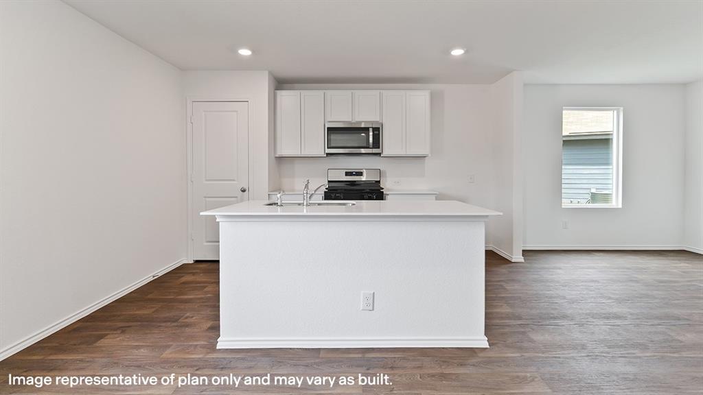 1711 Potomac Lane Blue Ridge, TX 75424 - Photo 20 of 26 a kitchen with a sink a microwave a stove and cabinets
