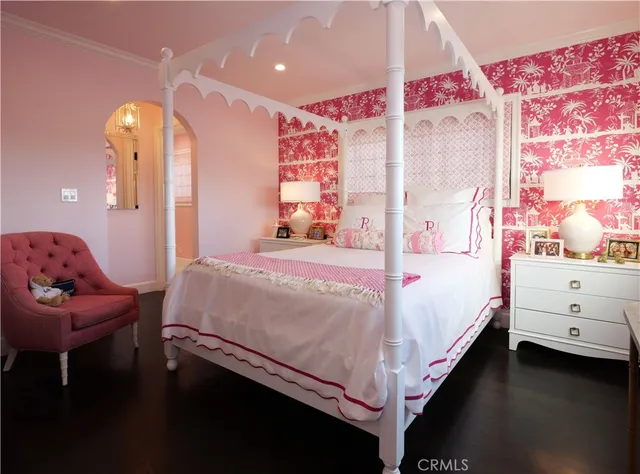 a bedroom with a bed and flat screen tv