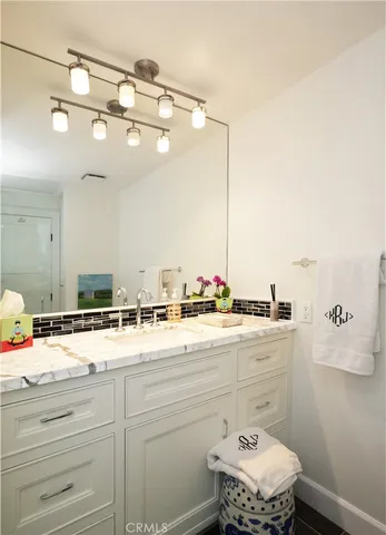 a spacious bedroom with a bed and wooden floor