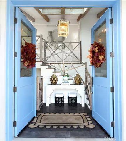 a dining room filled chandelier and kitchen view