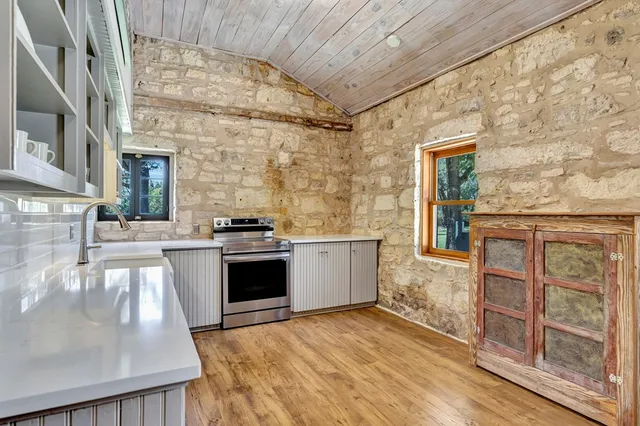 a view of a hallway with wooden floor and entryway