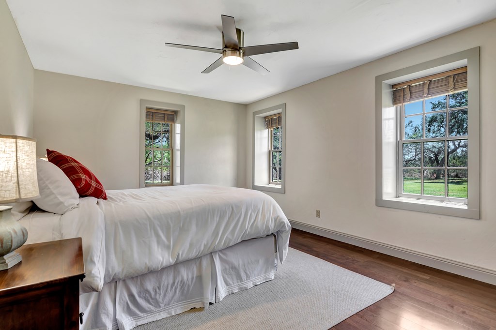268 Marschall Creek Road Fredericksburg, TX 78624 - Photo 19 of 77 a bedroom with a bed and a window