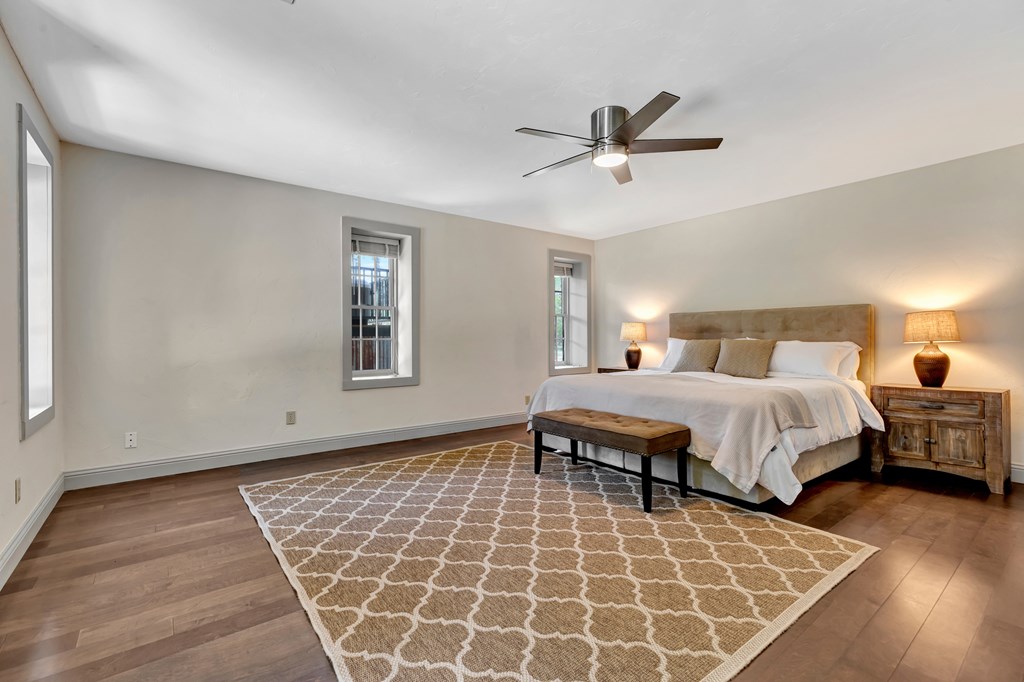 268 Marschall Creek Road Fredericksburg, TX 78624 - Photo 24 of 77 a bedroom with a bed and wooden floor