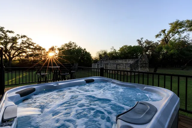 a wooden fence covered with tall trees