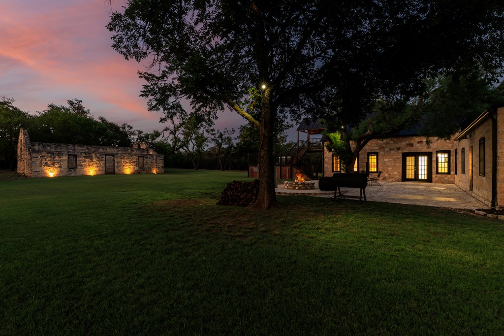 268 Marschall Creek Road Fredericksburg, TX 78624 - Photo 62 of 77 a backyard of a house with lots of green space table and chairs