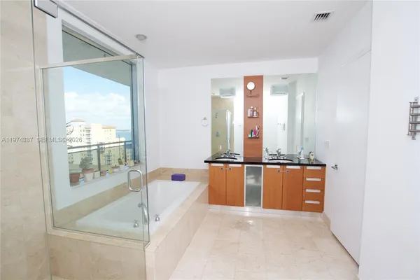 a bathroom with a bathtub and next to a window