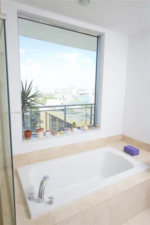 a bathroom with a bathtub toilet and shower