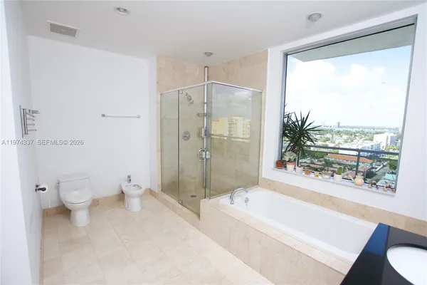 a bathroom with a sink toilet and a mirror