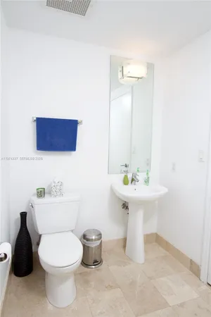 a bathroom with a sink a toilet and a shower curtain