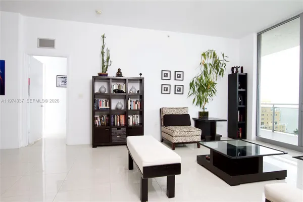 a living room with furniture and a potted plant