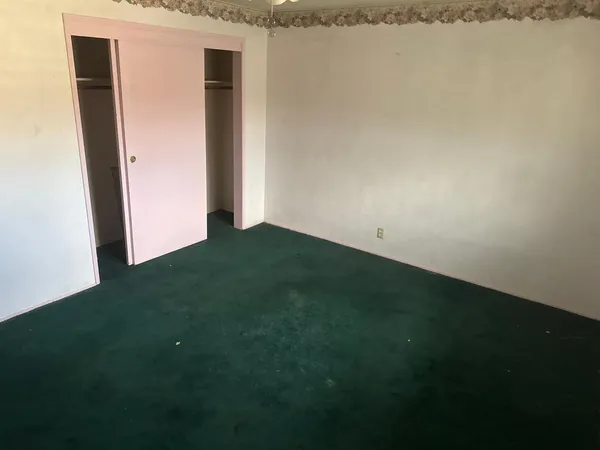 a view of empty room with floor to ceiling window