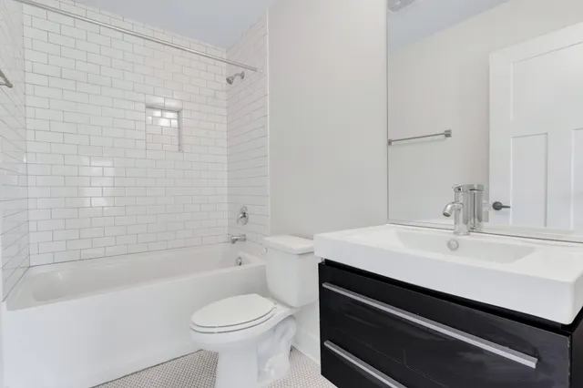 a bathroom with a sink a toilet and bathtub