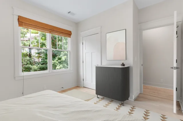 a bedroom with a bed and a window