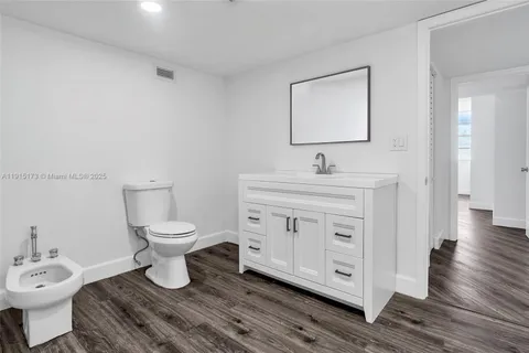 a bathroom with a sink toilet and mirror